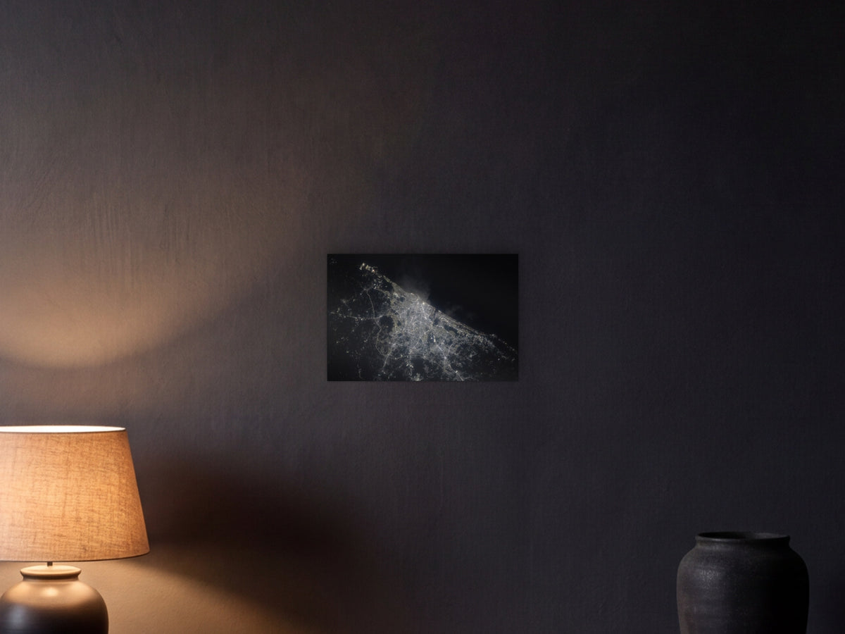 Chennai City Lights shown in a graphite plaster wall at night, lit by a console lamp - scale render at 45 × 30 cm