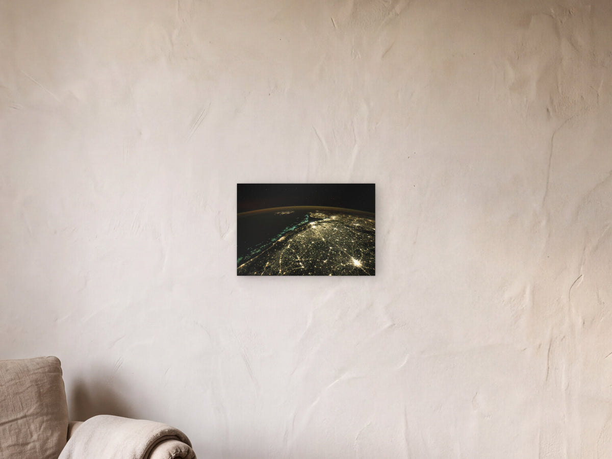 Fishing Boats and City Lights shown in a limewash reading corner beside an armchair and a floor lamp - scale render at 45 × 30 cm