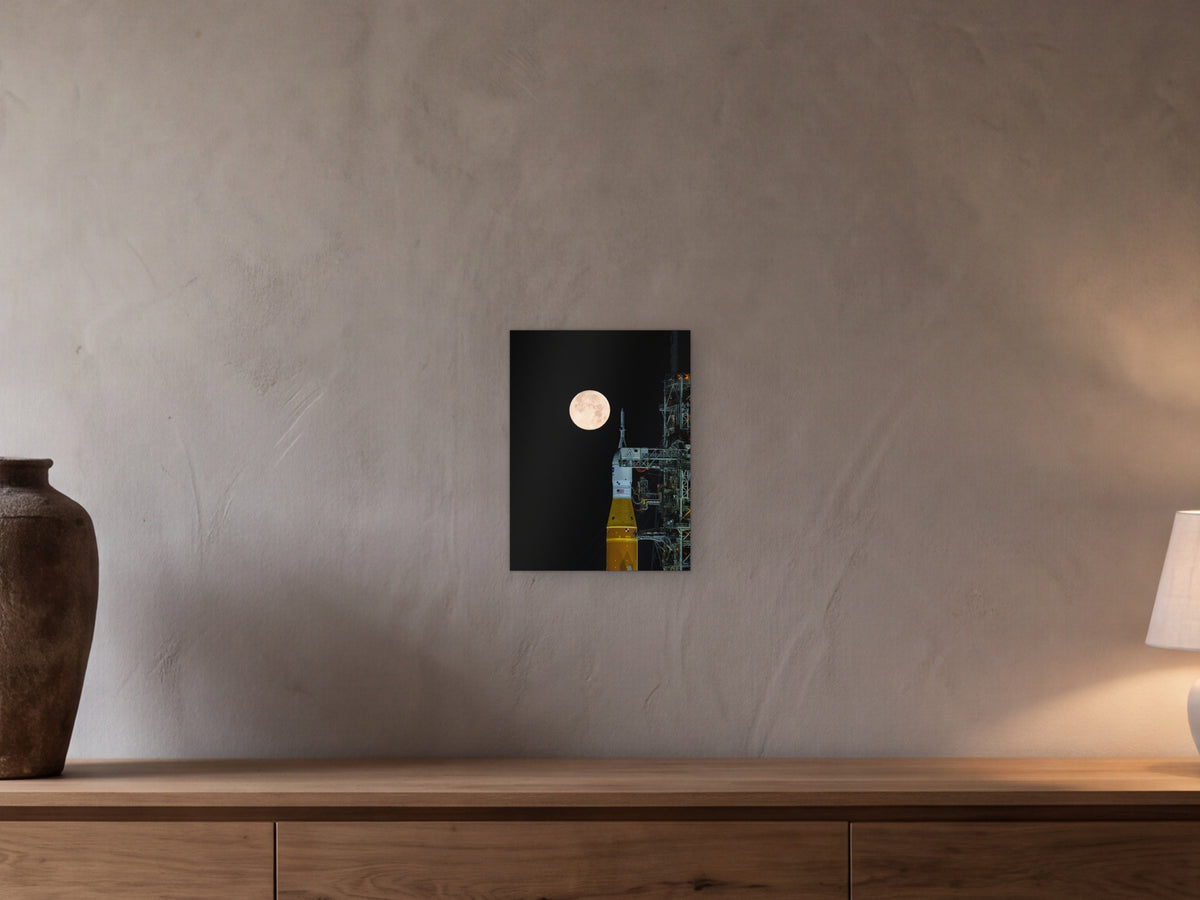 Full Moon over Artemis II shown in a beamed room with a greige plaster wall above a long oak sideboard - scale render at 30 × 40 cm