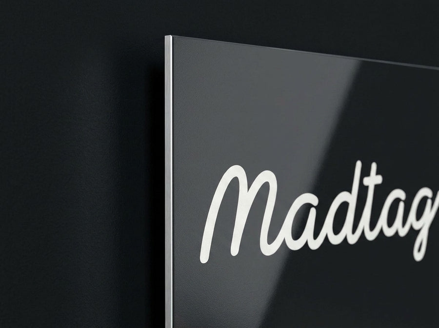The edge of a Madtag aluminium print, a thin bright line, floating clear of a dark wall.