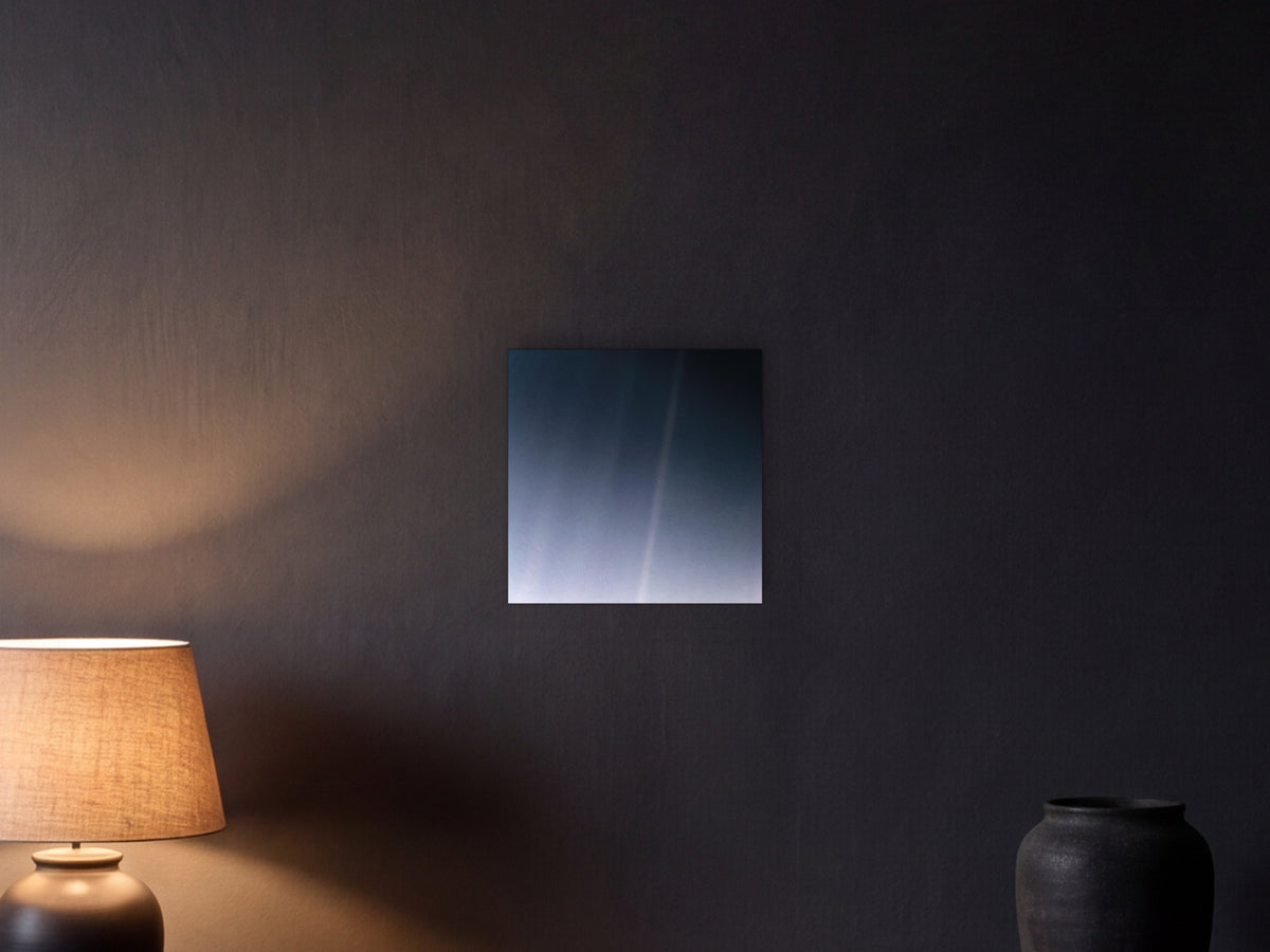 Pale Blue Dot Revisited (2020 remaster) shown in a graphite plaster wall at night, lit by a console lamp - scale render at 40 × 40 cm