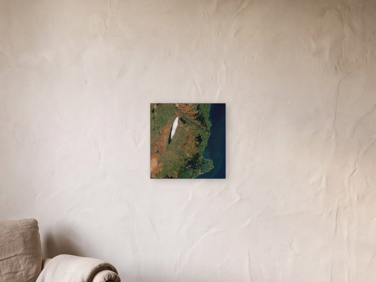 A Particular Lenticular Cloud shown in a limewash reading corner beside an armchair and a floor lamp - scale render at 40 × 40 cm